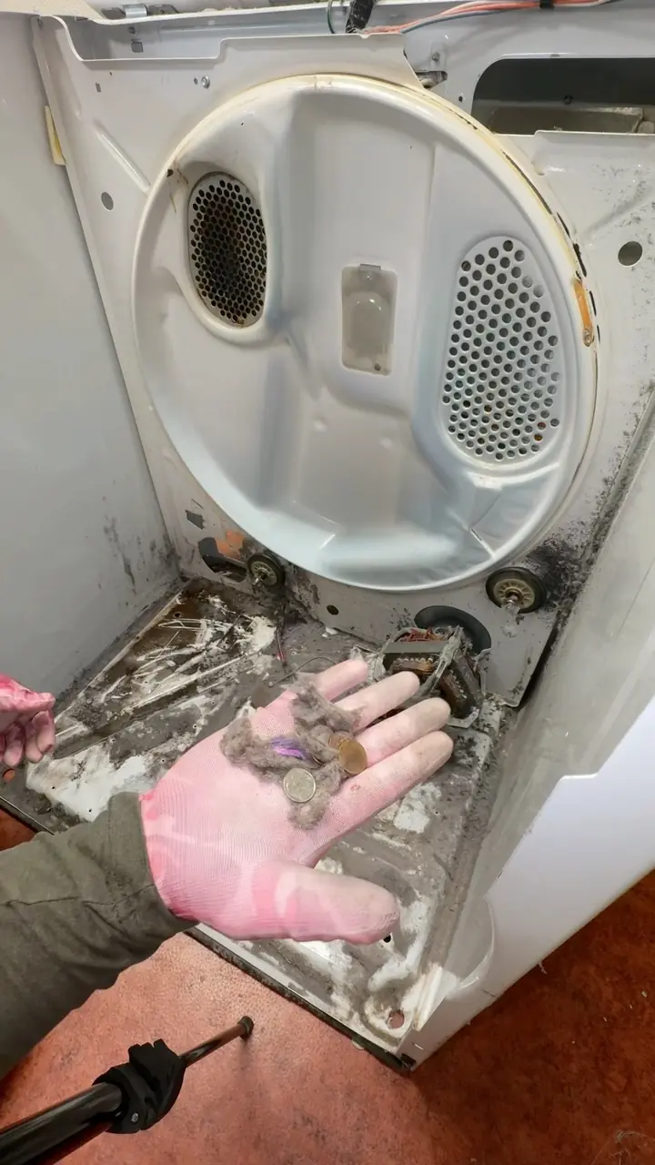 A lint trap next to the full dryer duct it connects to