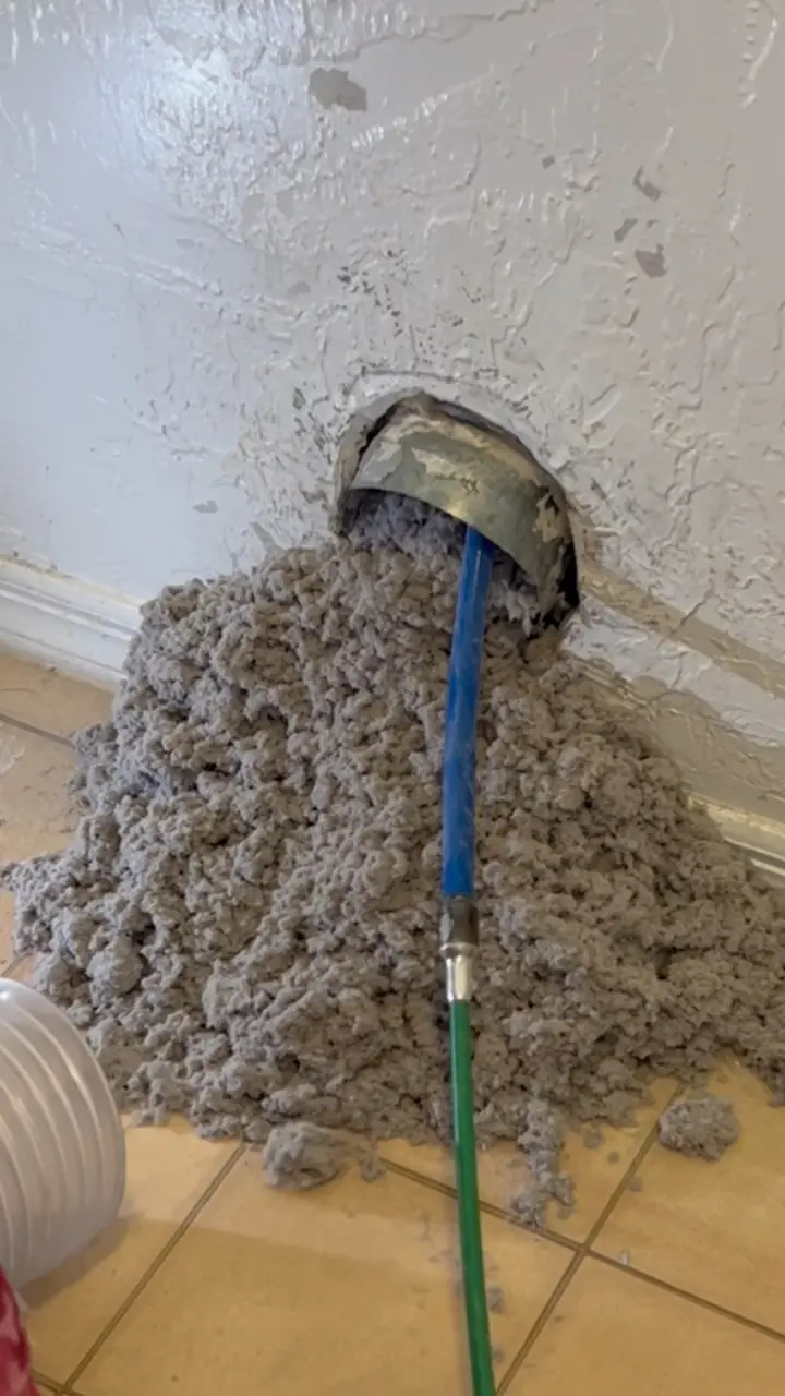 Decades of packed lint being vacuumed out of an uncleaned dryer vent